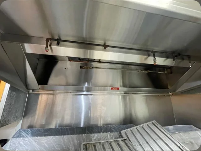 Cleaned hood and backsplash with removed filters in the foreground.