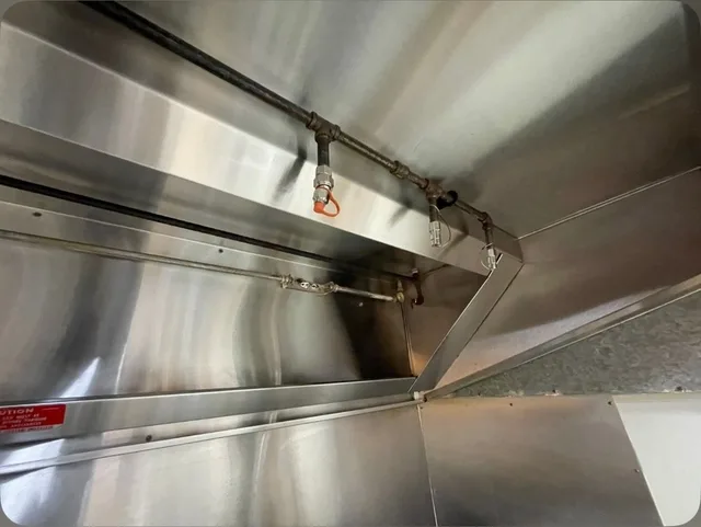 The same right hood interior after cleaning, including the wall and lower collection channel.